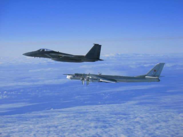 Japanese F-15 fighter jet escorting Russian nuclear-capable Tupolev Tu-95MS bomber