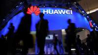 Visitors pass in front of Huawei’s display at the Mobile World Congress in Barcelona. Lluis Gene | AFP | Getty Images