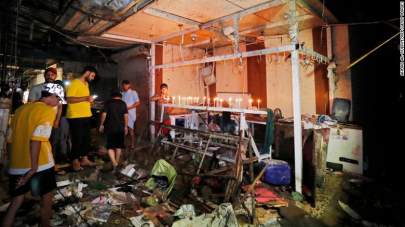 Iraqis light candles at the site of the explosion in a popular market in the mostly Shiite neighbourhood of Sadr City, east of Baghdad, on July 19, 2021.