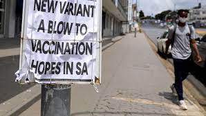 FILE - A man walks past newspaper billboards during the coronavirus disease (COVID-19) outbreak in Johannesburg, South Africa, Feb. 8, 2021 - Reuters