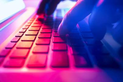  Image: Getty Hands typing on a laptop keyboard.