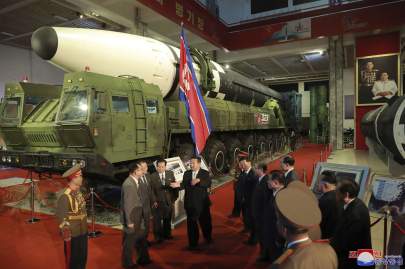 © Provided by Associated Press In this photo provided by the North Korean government, North Korean leader Kim Jong Un, center, speaks in front of what the North says an intercontinental ballistic missile displayed at an exhibition of weapons systems in Pyongyang, North Korea, Monday, Oct. 11, 2021. Kim reviewed the rare exhibition and vowed to build an “invincible” military, as he accused the United States of creating regional tensions and lacking action to prove it has no hostile intent toward the North, state media reported Tuesday. Independent journalists were not given access to cover the event depicted in this image distributed by the North Korean government. The content of this image is as provided and cannot be independently verified. Korean language watermark on image as provided by source reads: "KCNA" which is the abbreviation for Korean Central News Agency. (Korean Central News Agency/Korea News Service via AP)