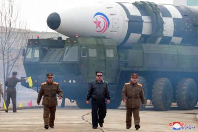  Korean Central News Agency - North Korean Supreme Leader Kim Jong Un walks flanked by top officials in front of the Hwasong-17 intercontinental ballistic missile ahead of his country