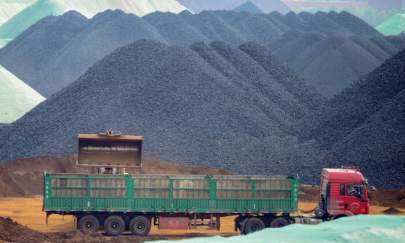 A truck transfers imported iron ore at a port in Rizhao in China's eastern Shandong Province on May 15, 2019. (STR/AFP via Getty Images)