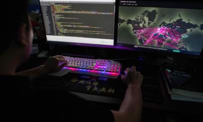 Prince, a member of the hacking group Red Hacker Alliance who refused to give his real name, uses a website that monitors global cyberattacks on his computer at their office in Dongguan, China's southern Guangdong province, on Aug. 4, 2020. (Nicolas Asfouri/AFP via Getty Images)