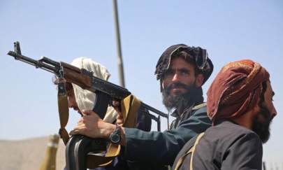 Taliban fighters stand guard in a vehicle along the roadside in Kabul on Aug.16, 2021, after a stunningly swift end to Afghanistan's 20-year war, as thousands of people mobbed the city's airport trying to flee the group's feared hardline brand of Islamist rule. (AFP via Getty Images)