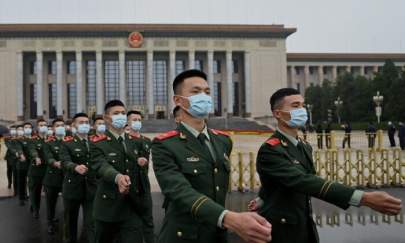 Military delegates march as they leave after the commemoration of the 110th anniversary of the Xinhai Revolution, which overthrew the Qing Dynasty and led to the founding of the Republic of China, at the Great Hall of the People in Beijing on Oct 9, 2021. (Noel Celis/AFP via Getty Images)