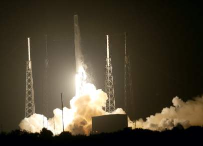 A SpaceX Falcon 9 rocket carrying a Dragon supply ship lifts off from a launchpad in Cape Canaveral, Florida, on a resupply mission to the International Space Station on Sept. 21, 2014. JOE RAEDLE/GETTY IMAGES