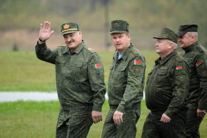 Belarus' President Alexander Lukashenko (L) waves as he arrives to inspect the joint Russian-Belarusian military exercises Zapad-2017 (West-2017) at a training ground near the town of Borisov on Sept. 20, 2017. (Photo by Sergei Gapon/AFP/Getty Images)