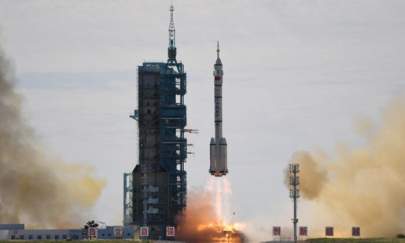 A Long March-2F carrier rocket, carrying the Shenzhou-12 spacecraft and a crew of three astronauts, lifts off from the Jiuquan Satellite Launch Centre in the Gobi desert, in China on June 17, 2021, the first crewed mission to China's new space station. (Greg Baker/AFP via Getty Images)