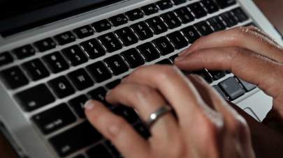 FILE- In this June 19, 2017, file photo, a person types on a laptop keyboard in North Andover, Mass. A new report by a global media consortium that expands the known target list of the Israeli hacker-for-hire firm NSO Group’s military-grade spyware provoked alarm Monday, July 19, 2021, among human rights and press freedom activists. They decried the near-complete absence of regulation of commercial surveillance tools. (AP Photo/Elise Amendola, File)