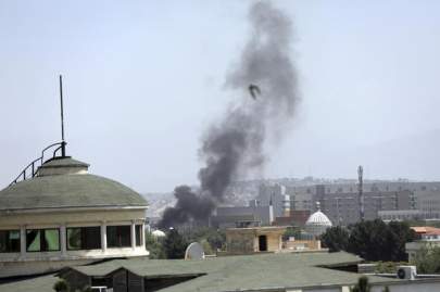 Smoke rises next to the U.S. Embassy in Kabul, Afghanistan, on Sunday, August 15, 2021. RAHMAT GUL / AP