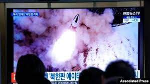 FILE - People watch a TV showing a file image of North Korea's missile launch shown during a news program at the Seoul Railway Station in Seoul, South Korea, Jan. 20, 2022.