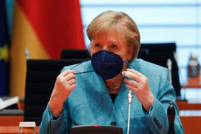 German Chancellor Angela Merkel adjusts her protective face mask during the weekly cabinet meeting at the Chancellery in Berlin, Germany, Wednesday, May 19, 2021. (Michele Tantussi/Pool via AP) THE ASSOCIATED PRESS