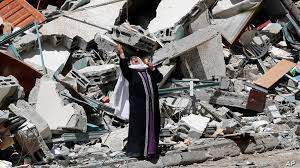 A Palestinian woman reacts near the rubble of a building housing The Associated Press, broadcaster Al-Jazeera and other media outlet, in Gaza City. The building was destroyed by an Israeli airstrike on Saturday. 