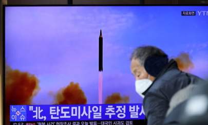 People watch a TV broadcasting file footage of a news report on North Korea firing a ballistic missile off its east coast, in Seoul, South Korea, on Jan. 5, 2022. (Kim Hong-Ji/Reuters)