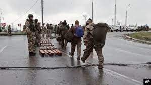 AP - In this photo taken from video released by the Russian Defense Ministry on May 19, 2022, Ukrainian servicemen, right, leave the besieged Azovstal steel plant in Mariupol, Ukraine.