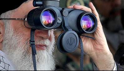 A man looking through binoculars