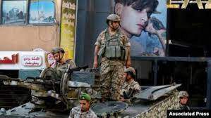 Associated Press - Lebanese army soldiers on their armored vehicle stand guard in Beirut, Oct. 15, 2021, at the site where deadly clashes erupted the previous day.