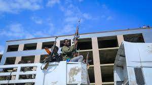 FILE - Armed Tigray forces, center, accompany captured Ethiopian government soldiers and allied militia members as they are paraded through the streets in open-top trucks, as are taken to a detention center in Mekele, the capital of the Tigray region